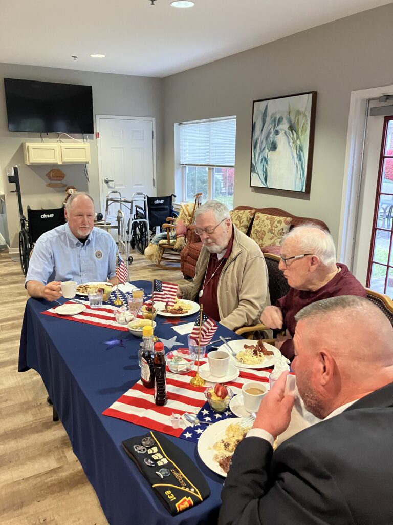 Residents enjoying a meal together in a common area.