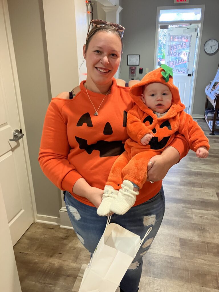 Resident and child in matching Halloween outfits