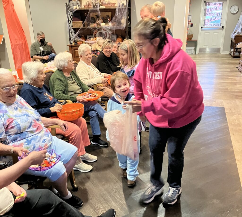 Residents and children engaged in an activity together.