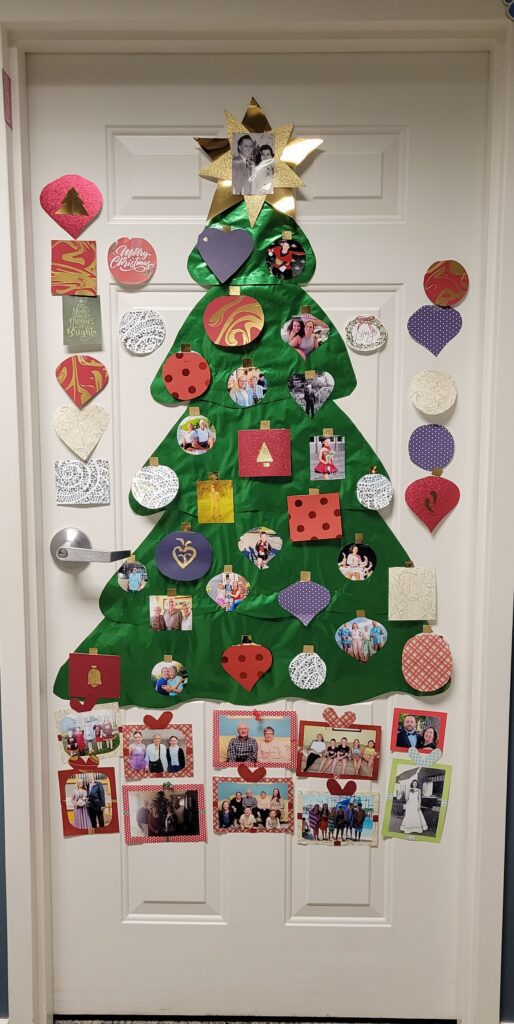 A decorated door with a Christmas tree design.