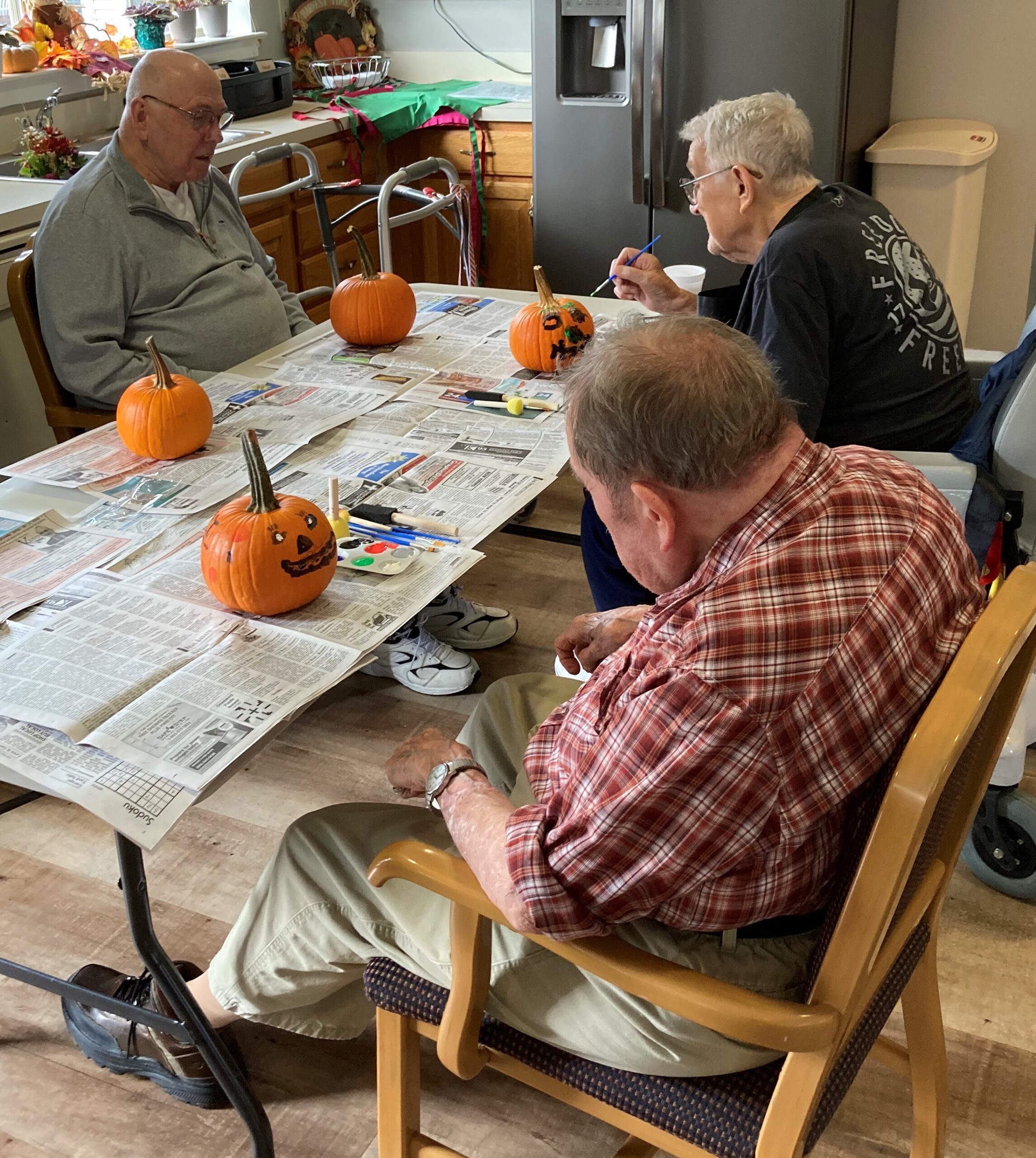 Residents decorating pumpkins for Halloween