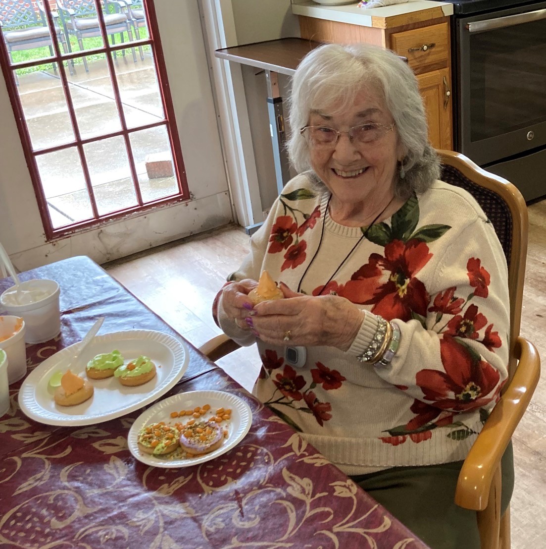 Senior woman enjoying decorated cookies