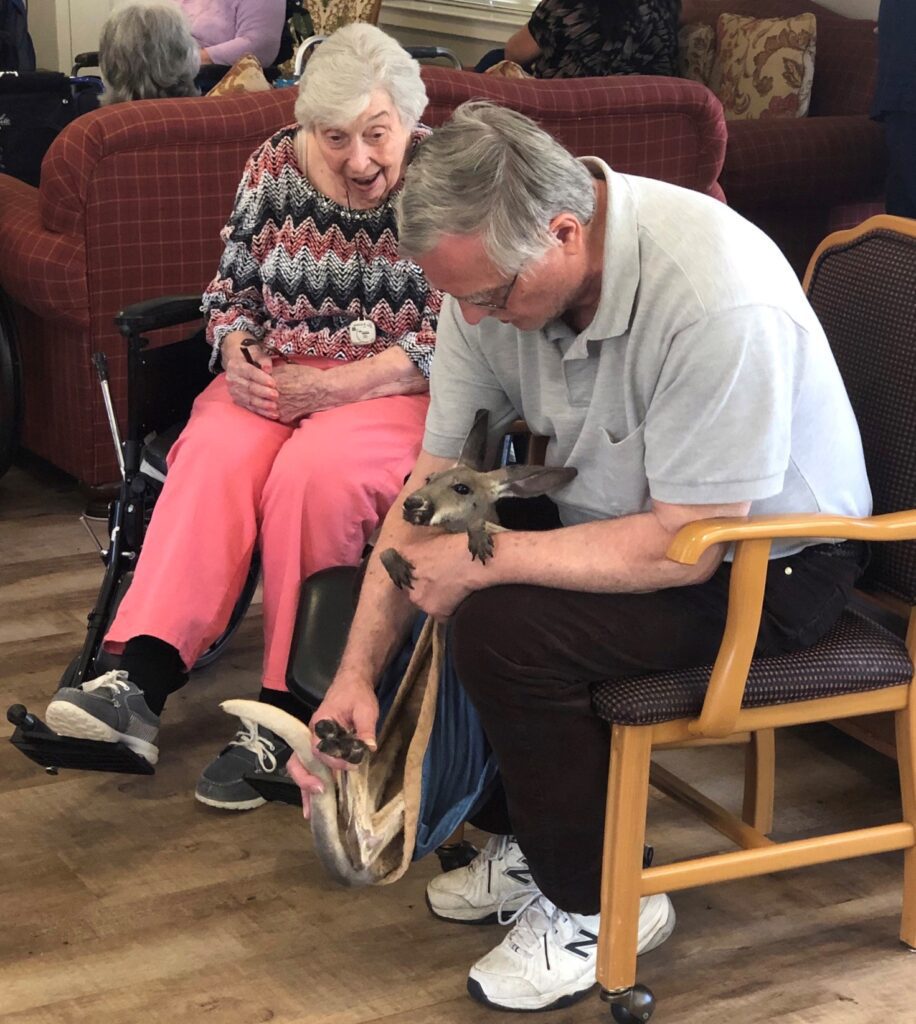 Residents interacting with a small animal.