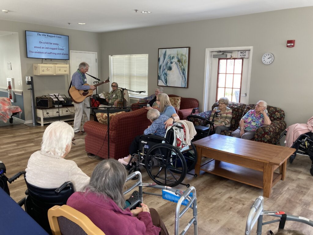 Residents enjoying a music activity in a common area.