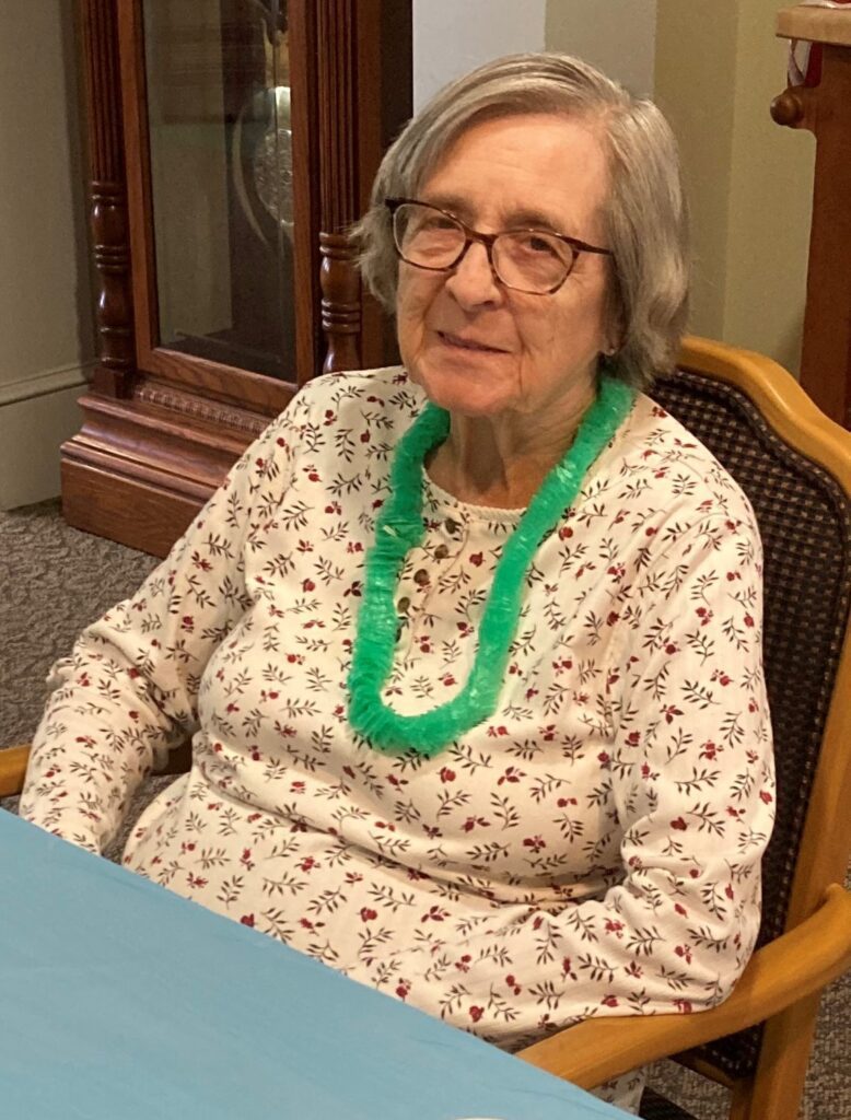 Resident smiling with a flower lei