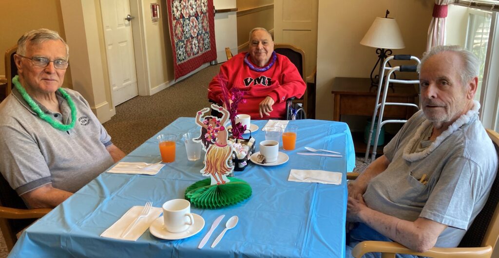 Residents enjoying snacks at a dining table.