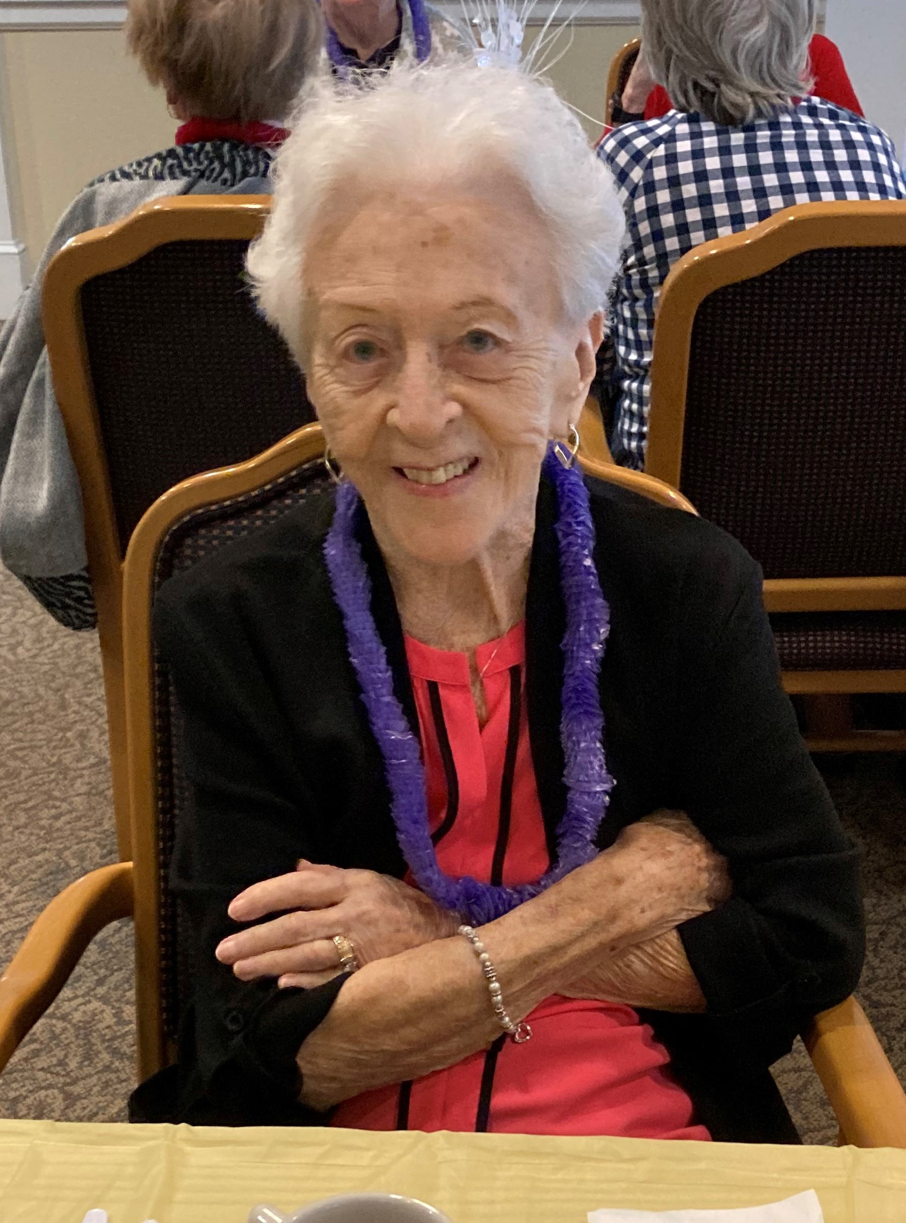 Smiling resident in a dining area at the facility.