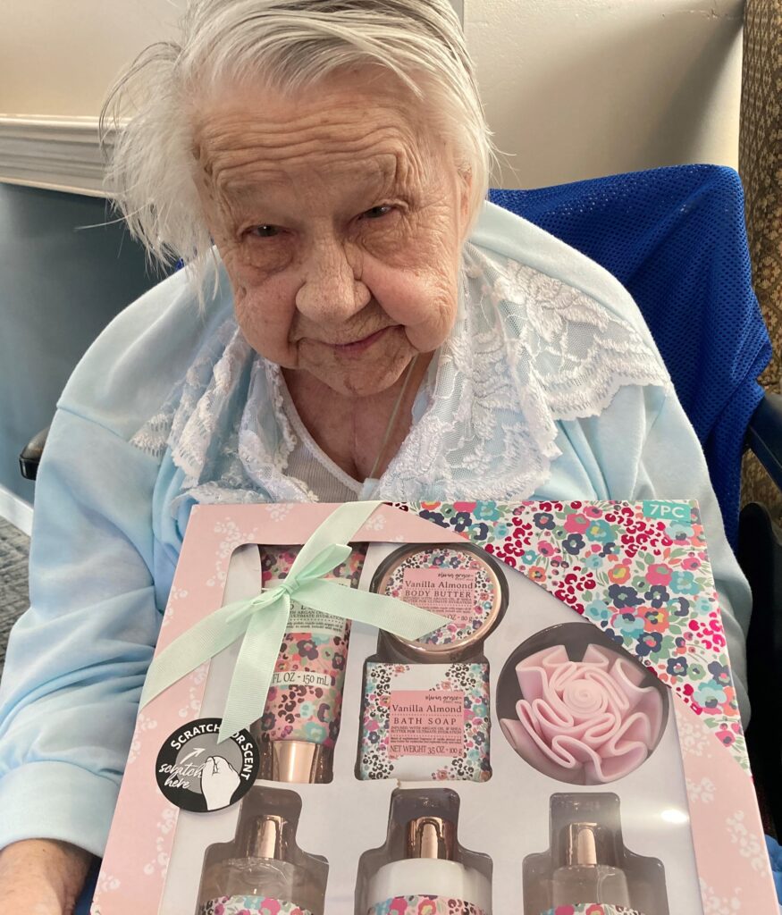 Elderly woman holding a gift set