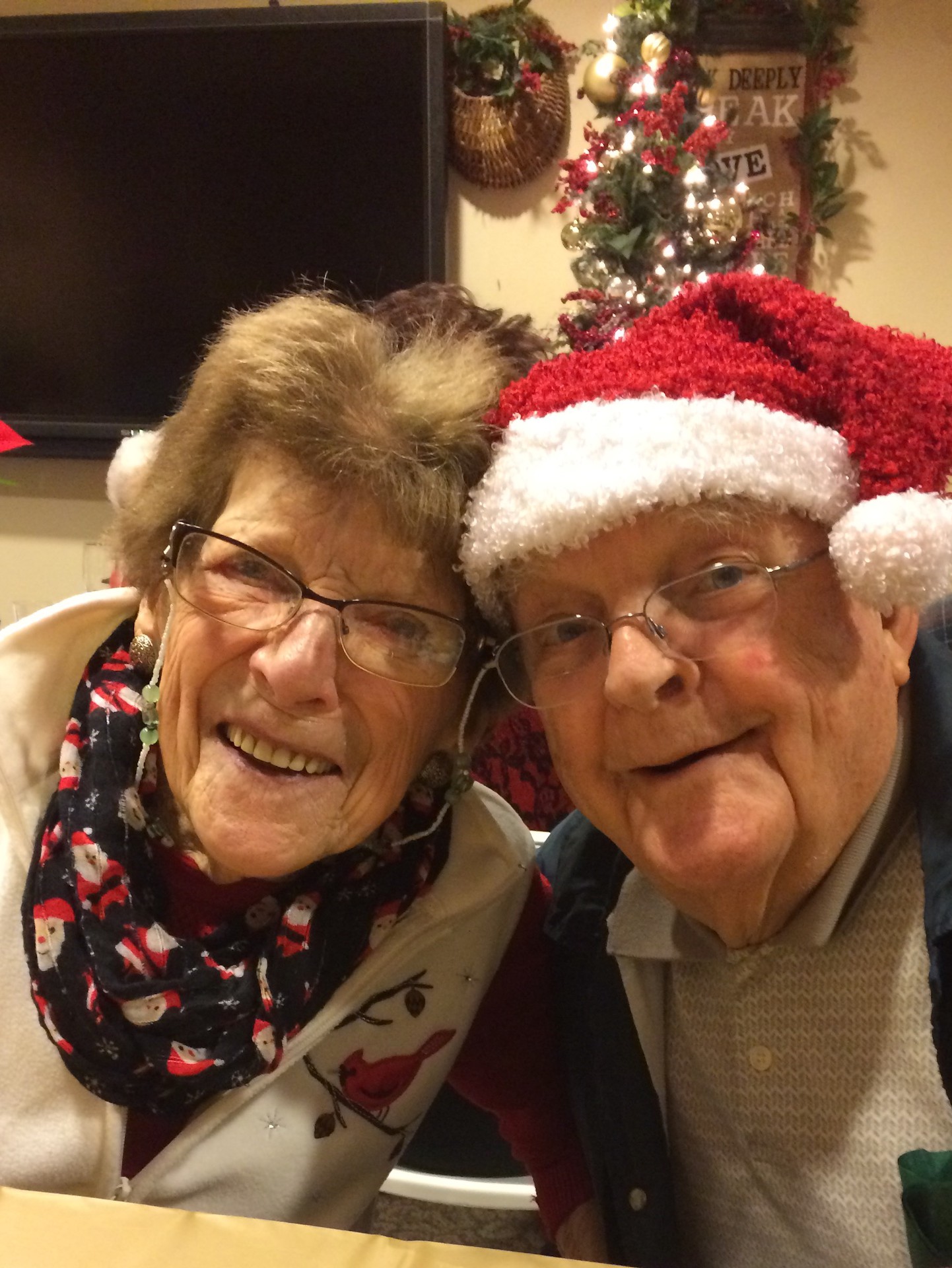 Residents celebrating with holiday hats and smiles.