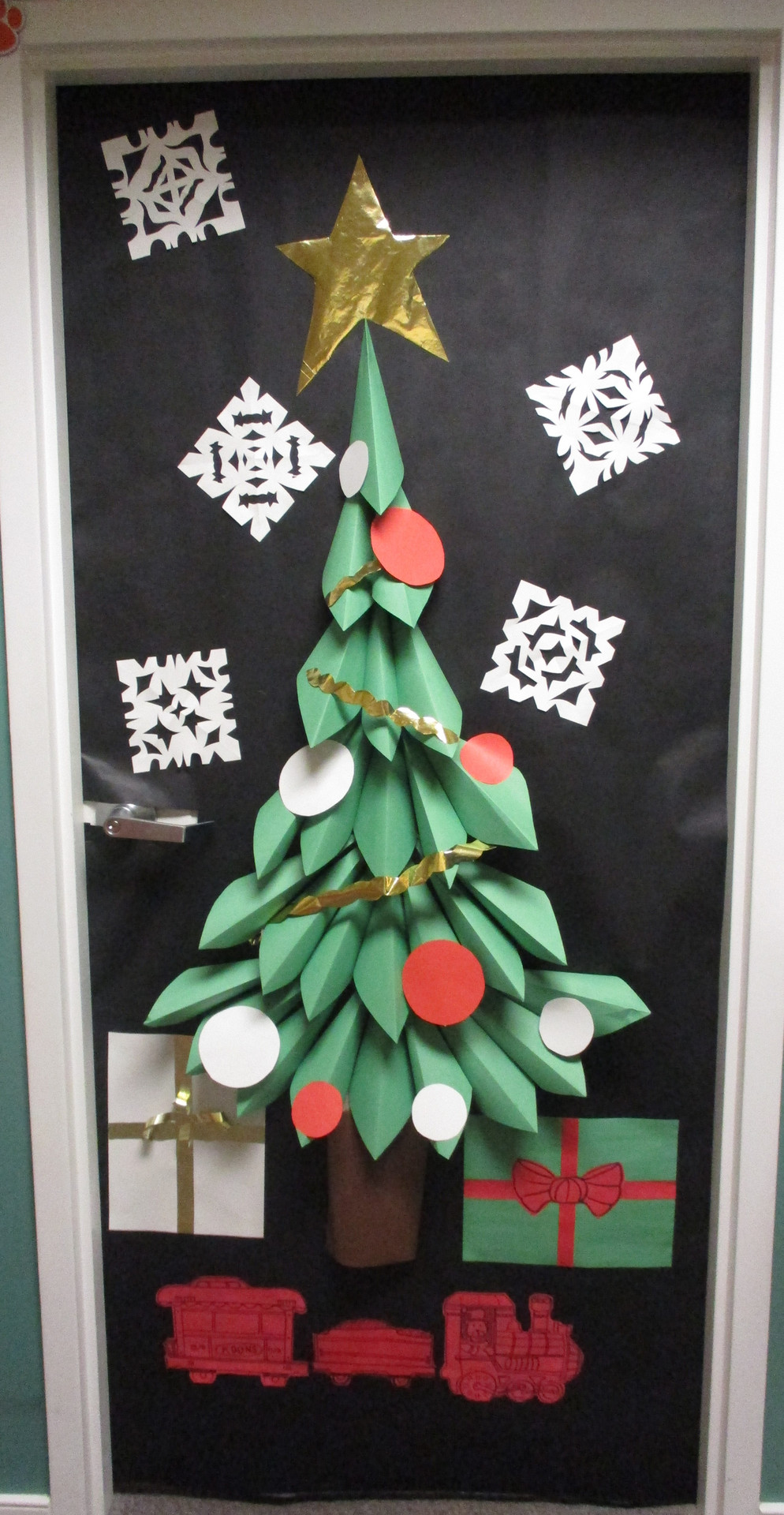 Holiday-themed door decoration with paper crafts.