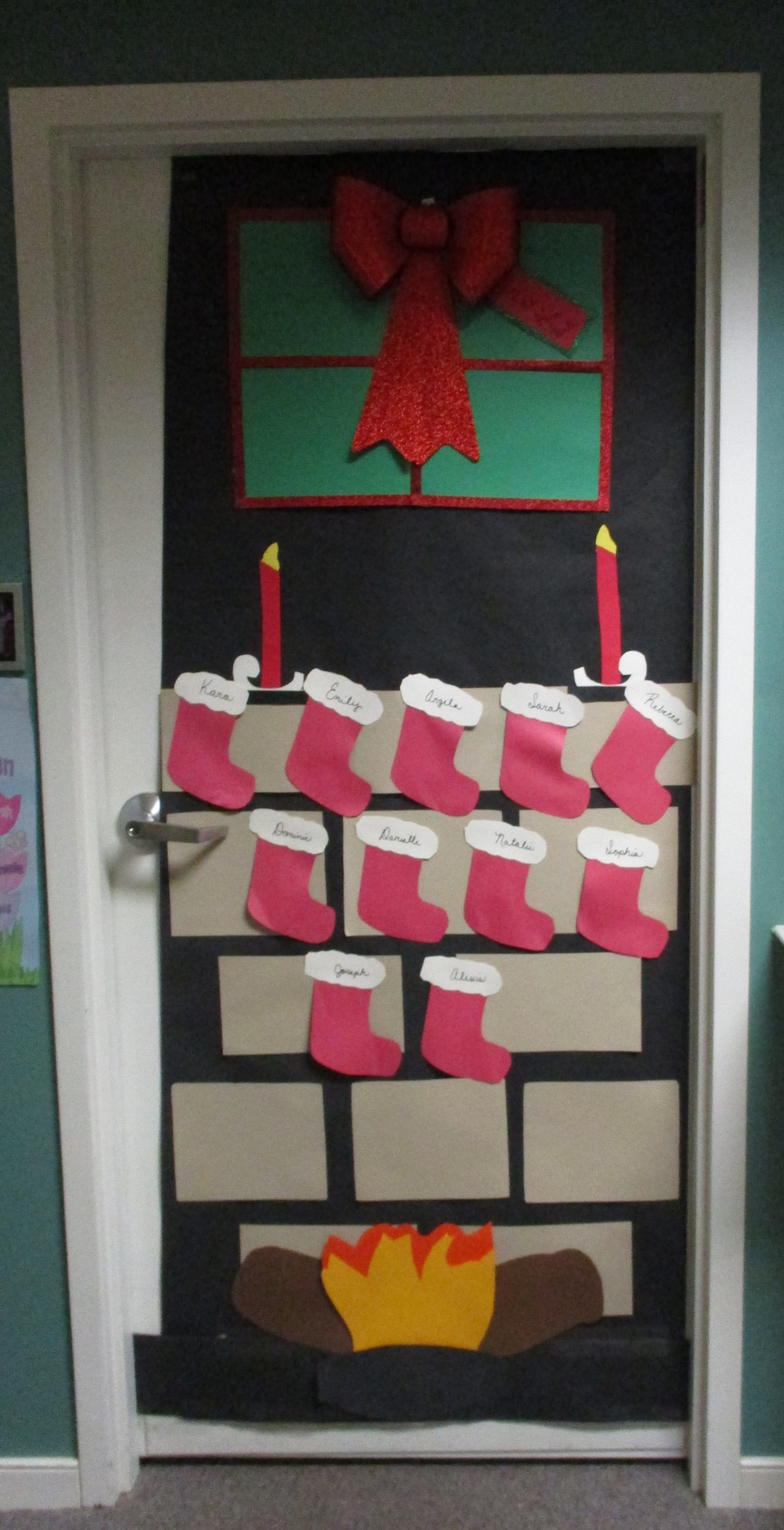 Decorative holiday door with stockings and wreath.