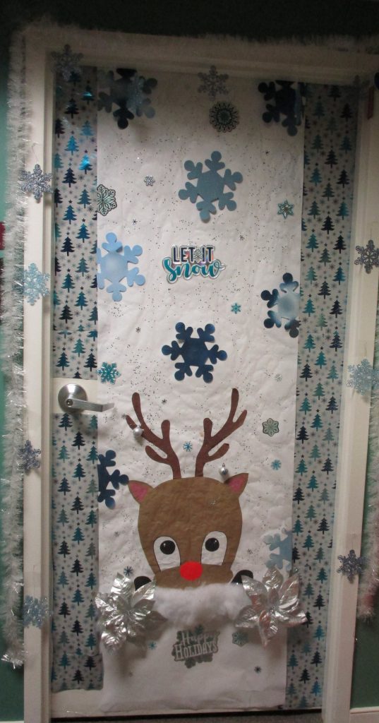 Festive holiday door decoration with reindeer theme.