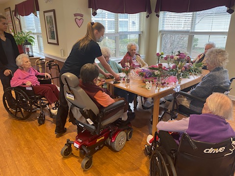 Residents and staff engaged in a floral activity