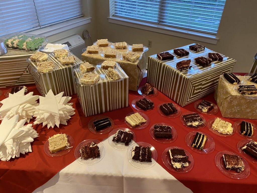 A table spread with assorted cakes and sweets.