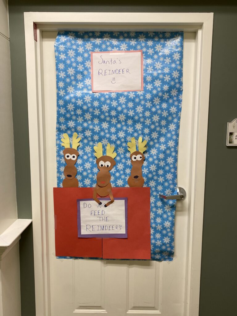 Decorative door display featuring reindeer art