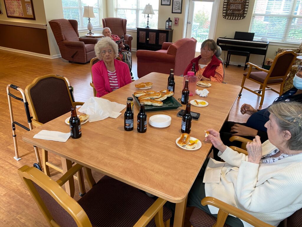 Residents enjoying food and drinks in a communal setting.