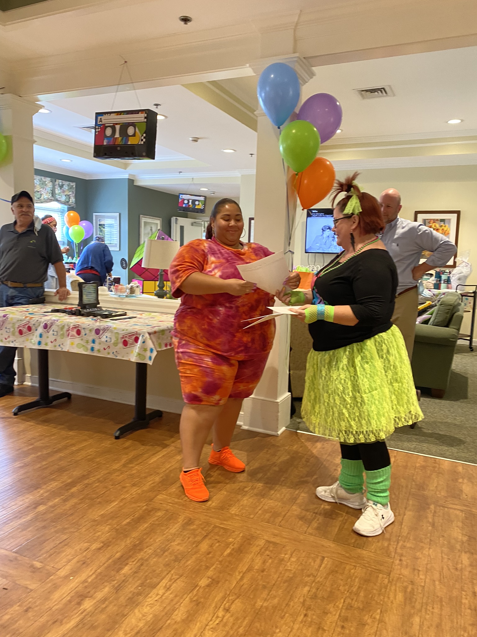 Residents enjoying a lively celebration indoors.