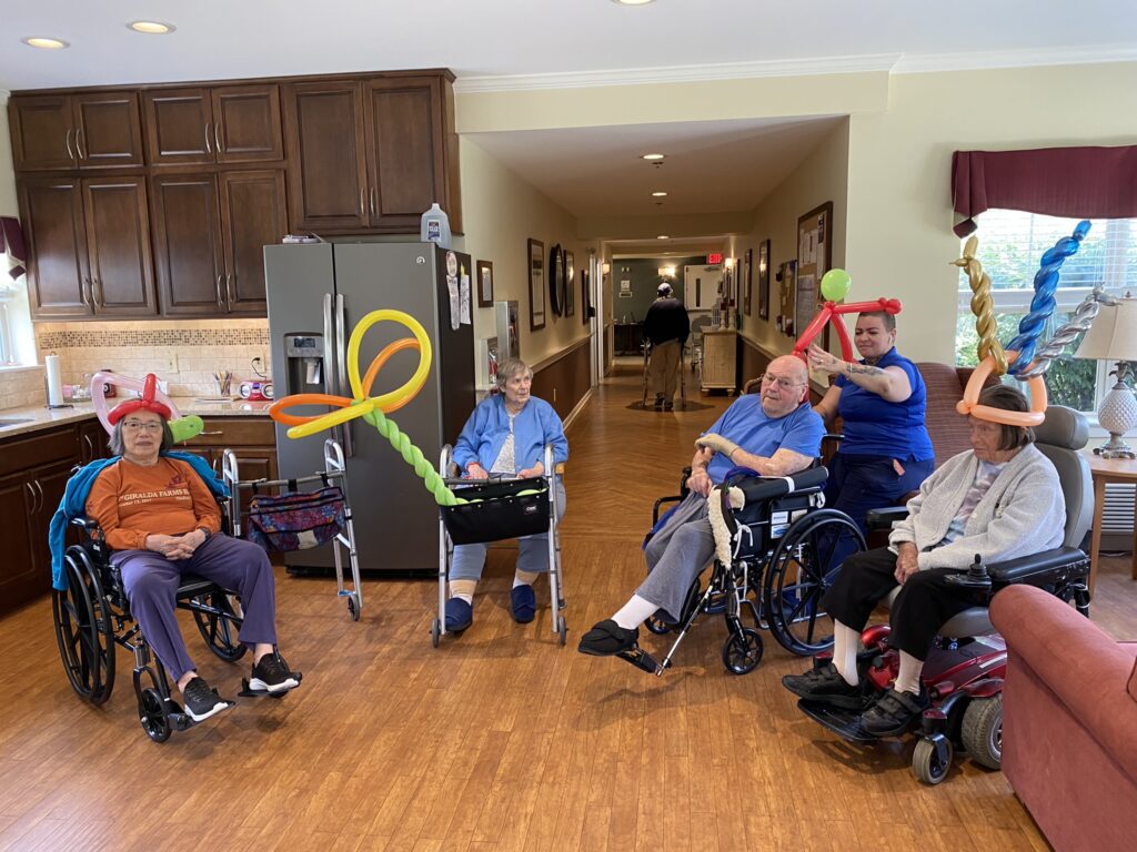 Residents enjoying a balloon activity in a common area