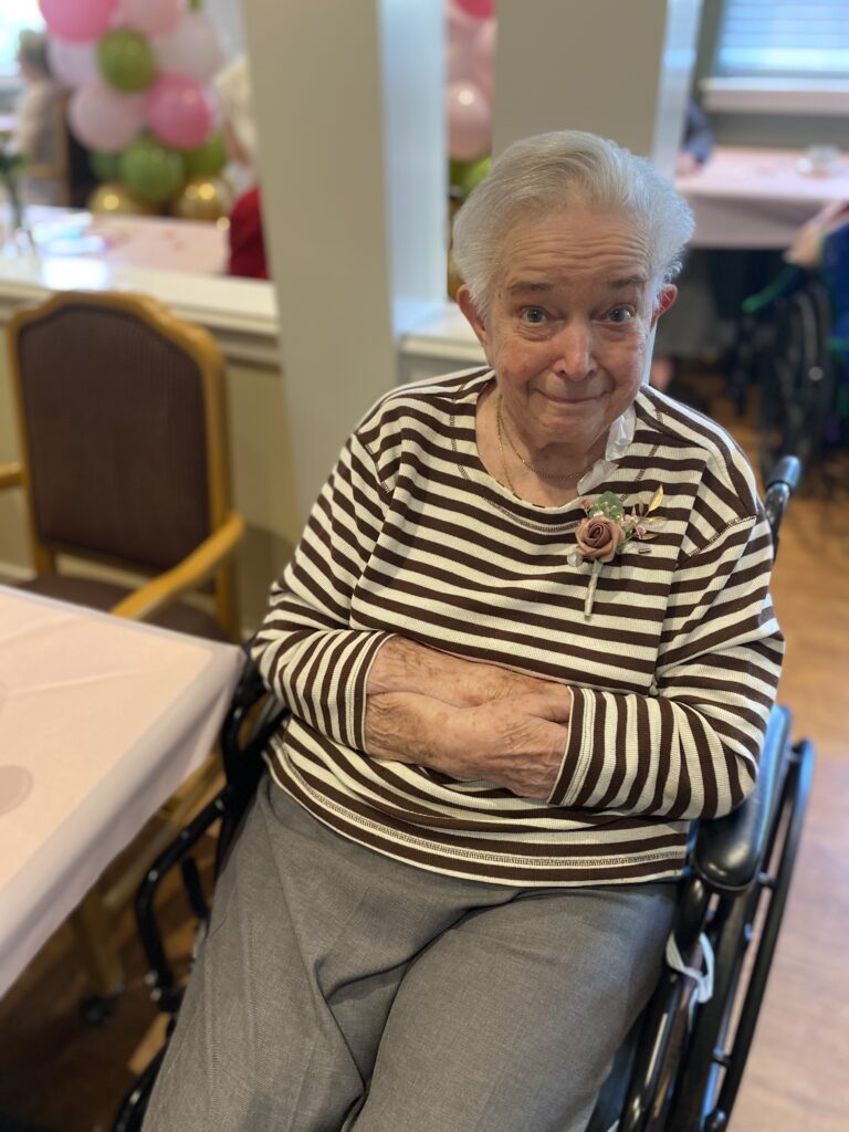 Senior woman smiling in a common area.