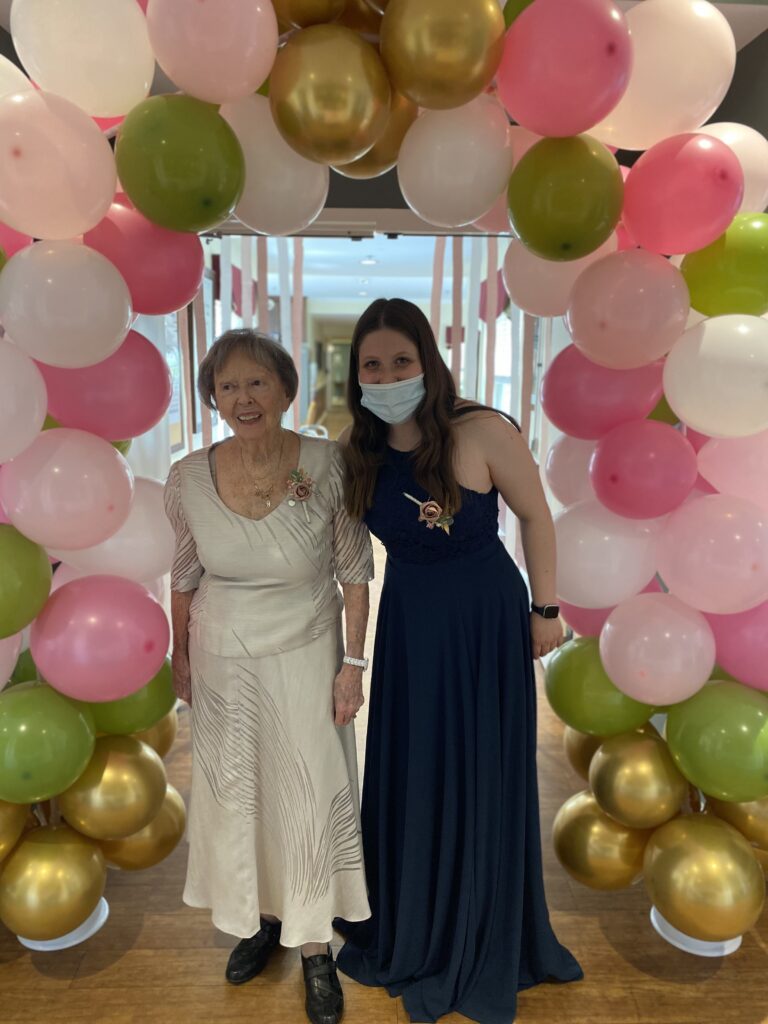 Resident and staff member celebrating at an event
