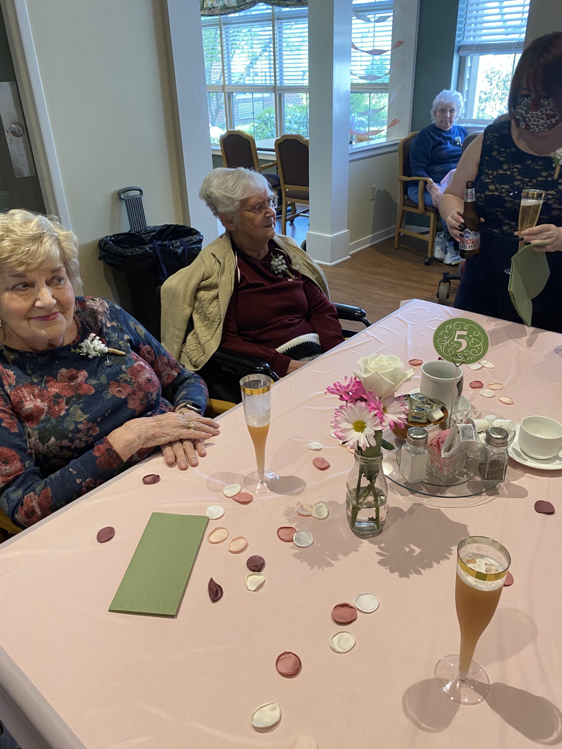 Residents celebrating with drinks and decorations.
