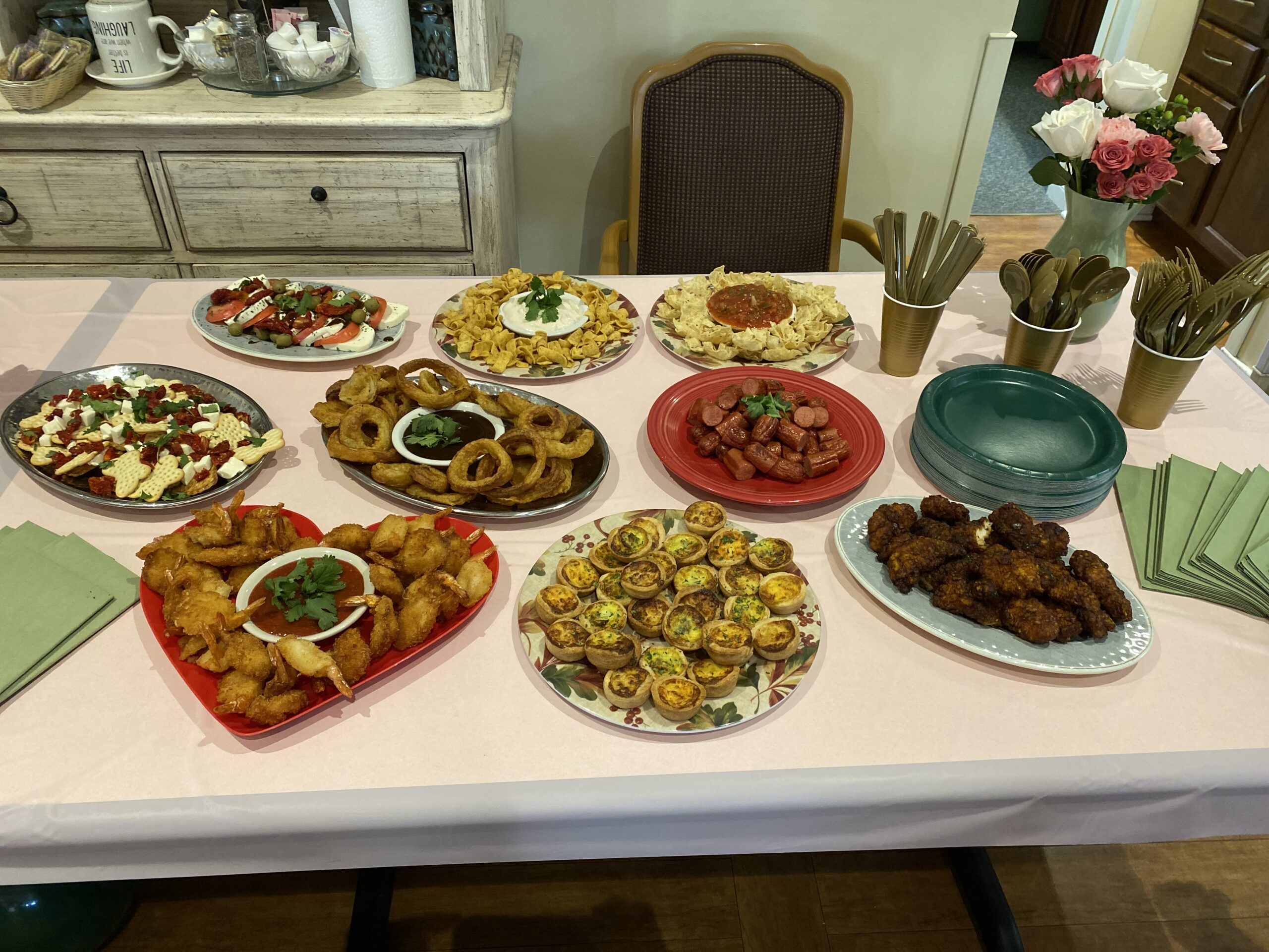 Table set with various food dishes for a gathering.