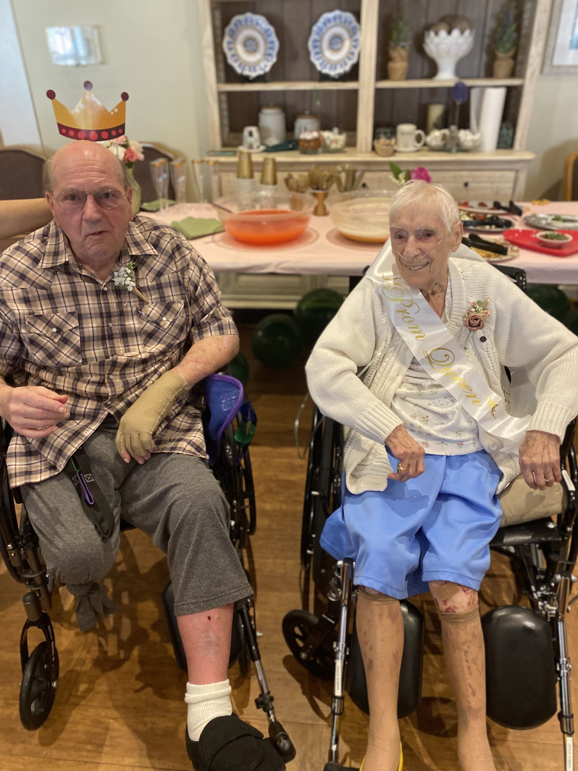 Two residents celebrating in a common area.