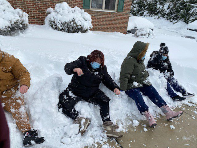 Residents enjoying winter snow outdoors