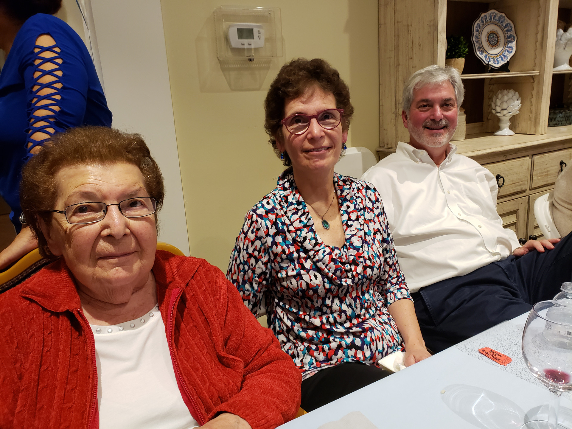 Three residents enjoying a gathering in a common area.