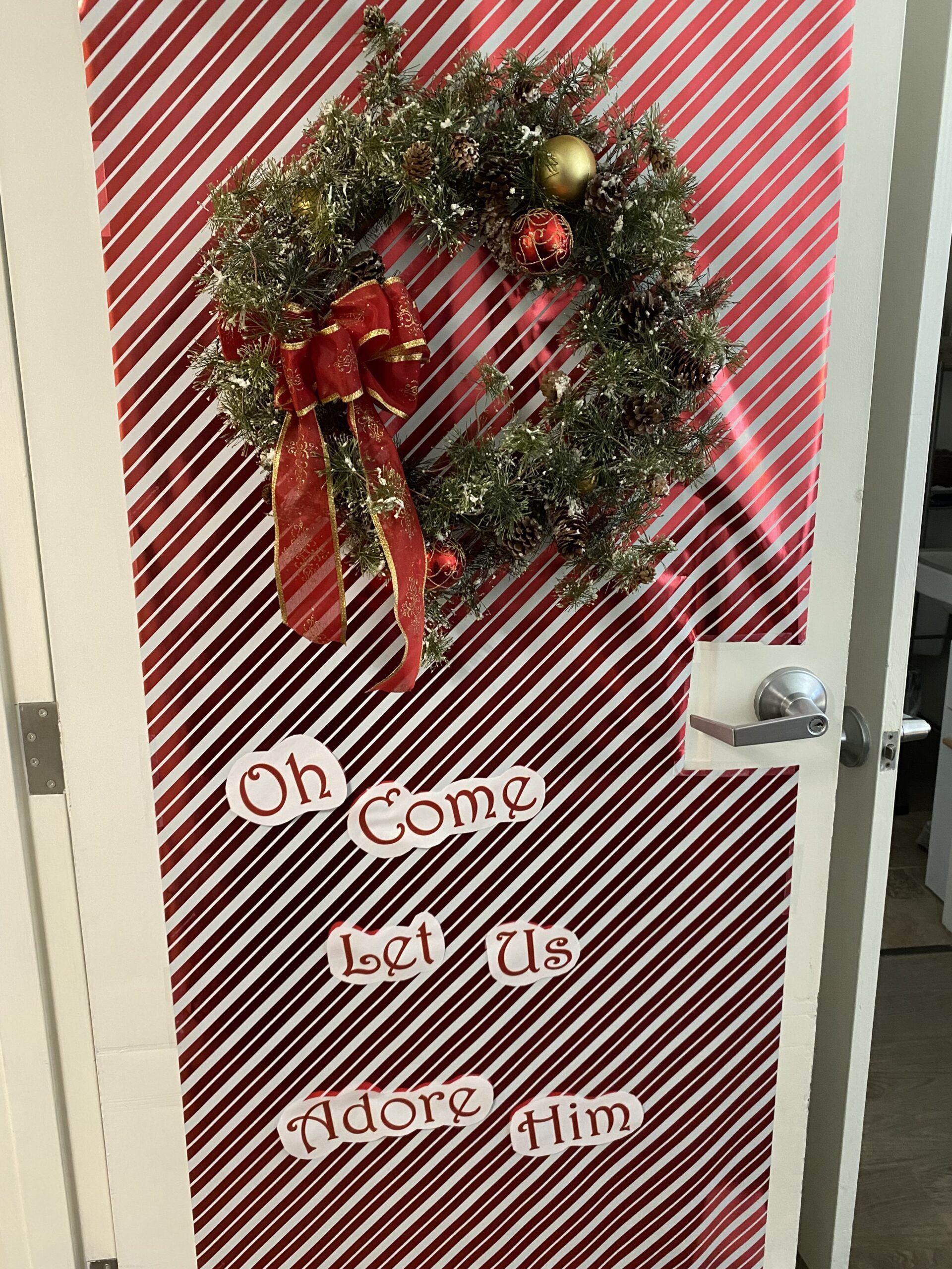 Decorative door with holiday wreath and text