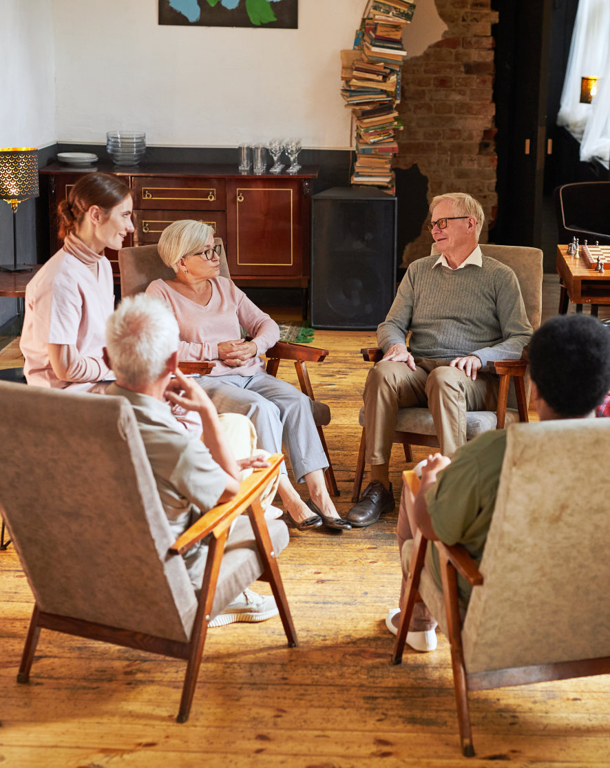 Residents and staff engaged in a conversation.
