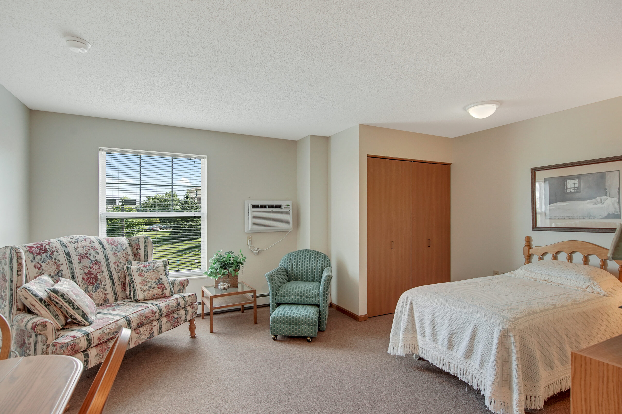 Bright private room with a bed and seating area