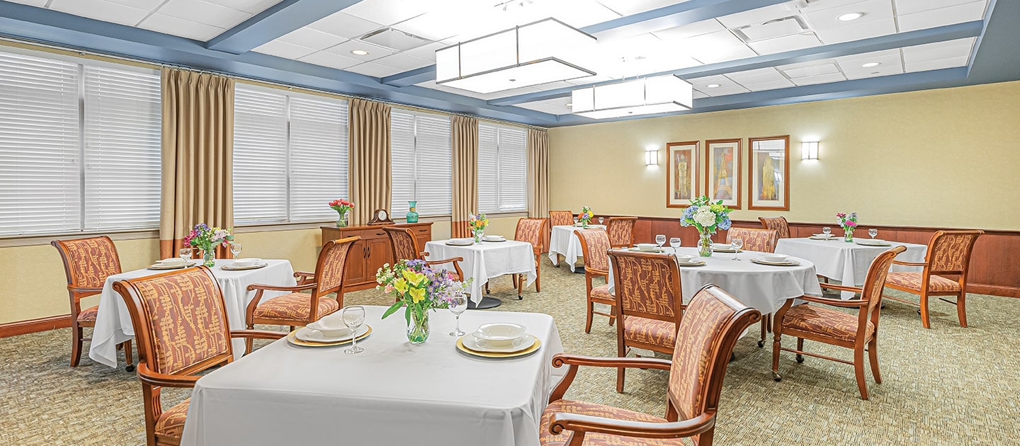 Bright dining room with tables set for a meal