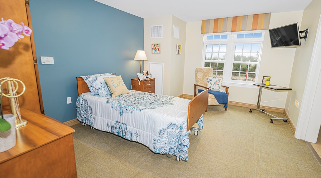 Cozy resident room with a bed and chair