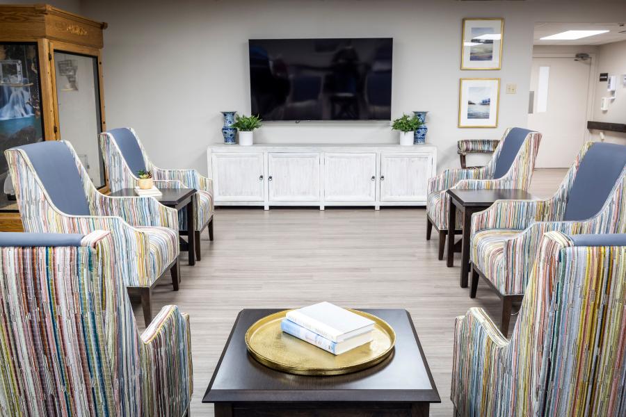 Bright common area with seating and entertainment.