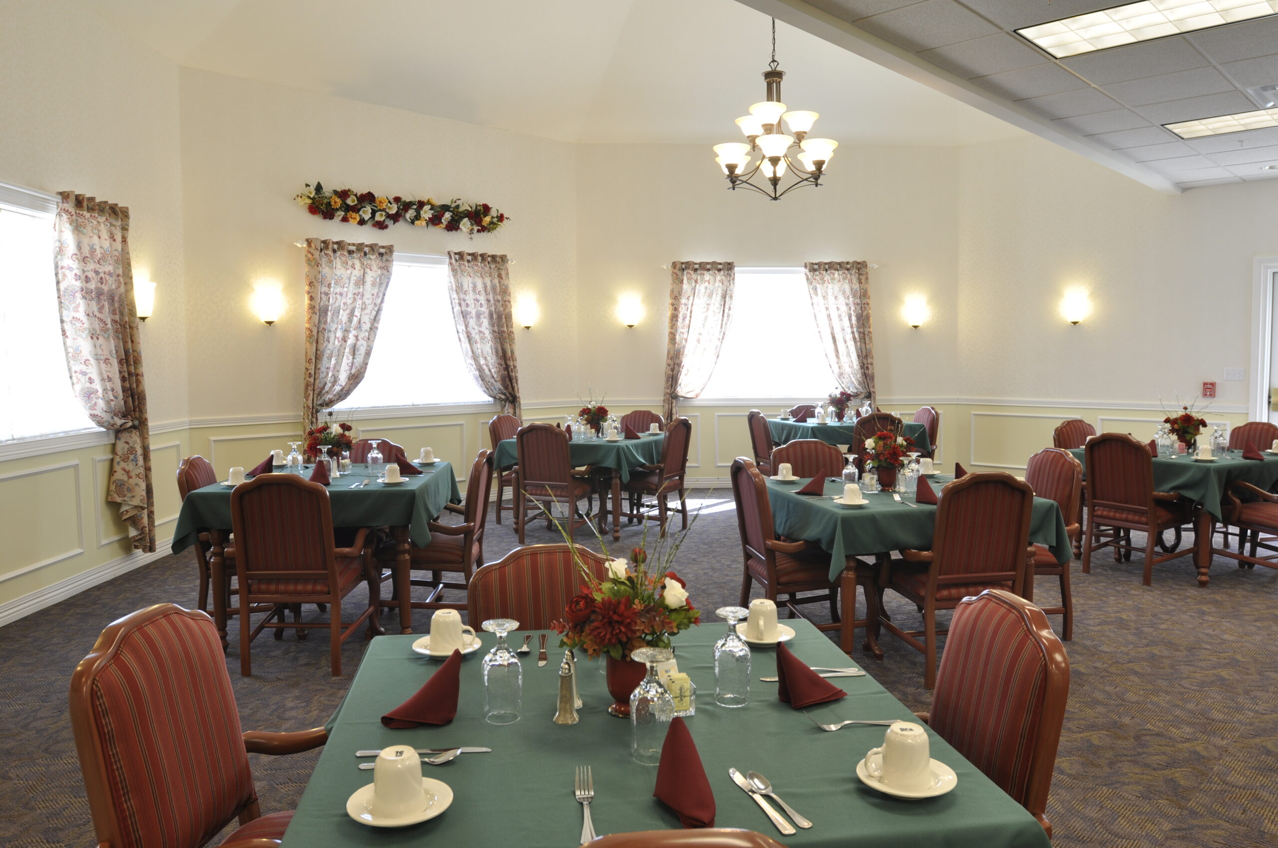 Bright dining room with tables set for meals