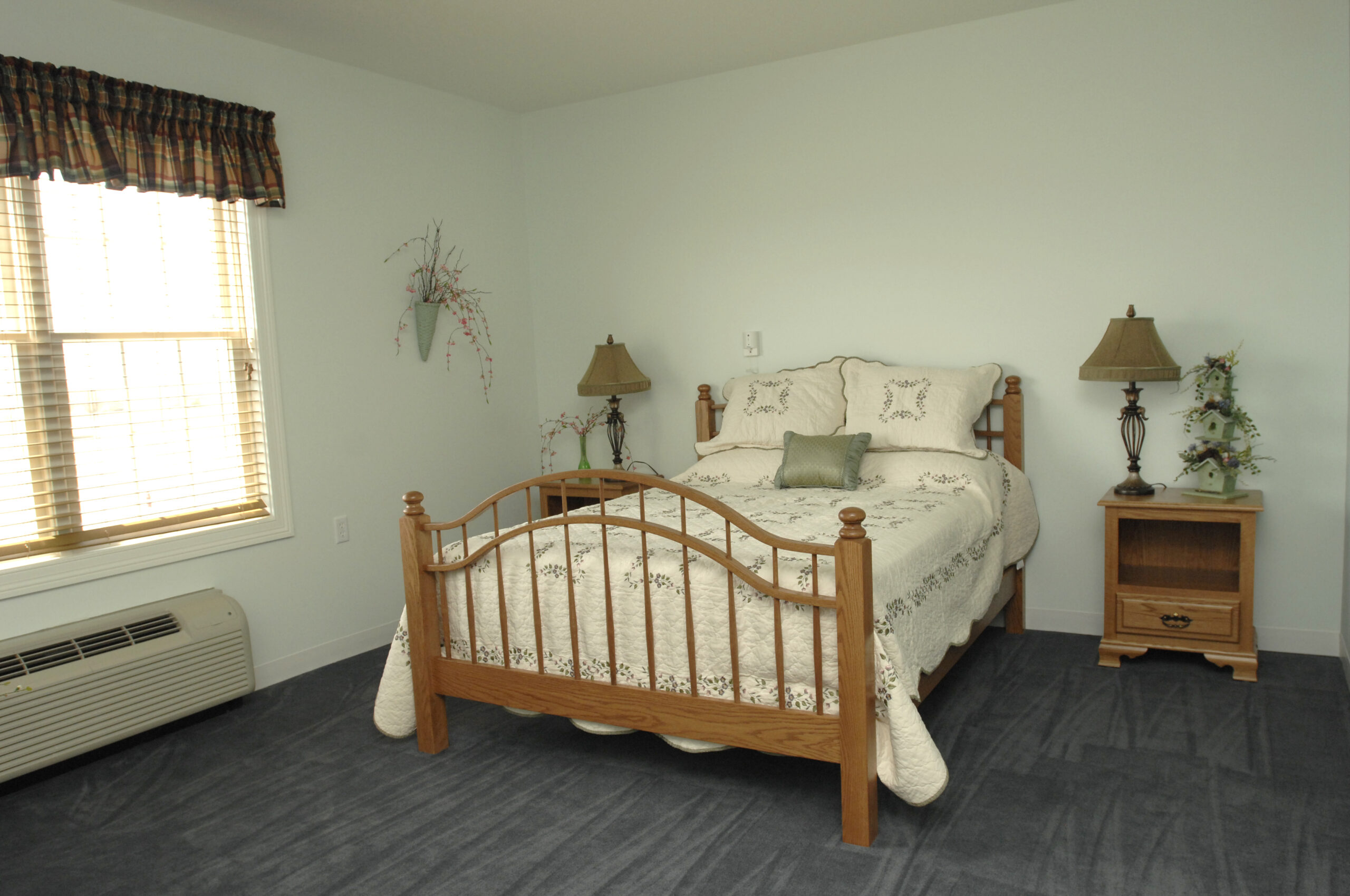 Cozy private bedroom with a floral bedspread