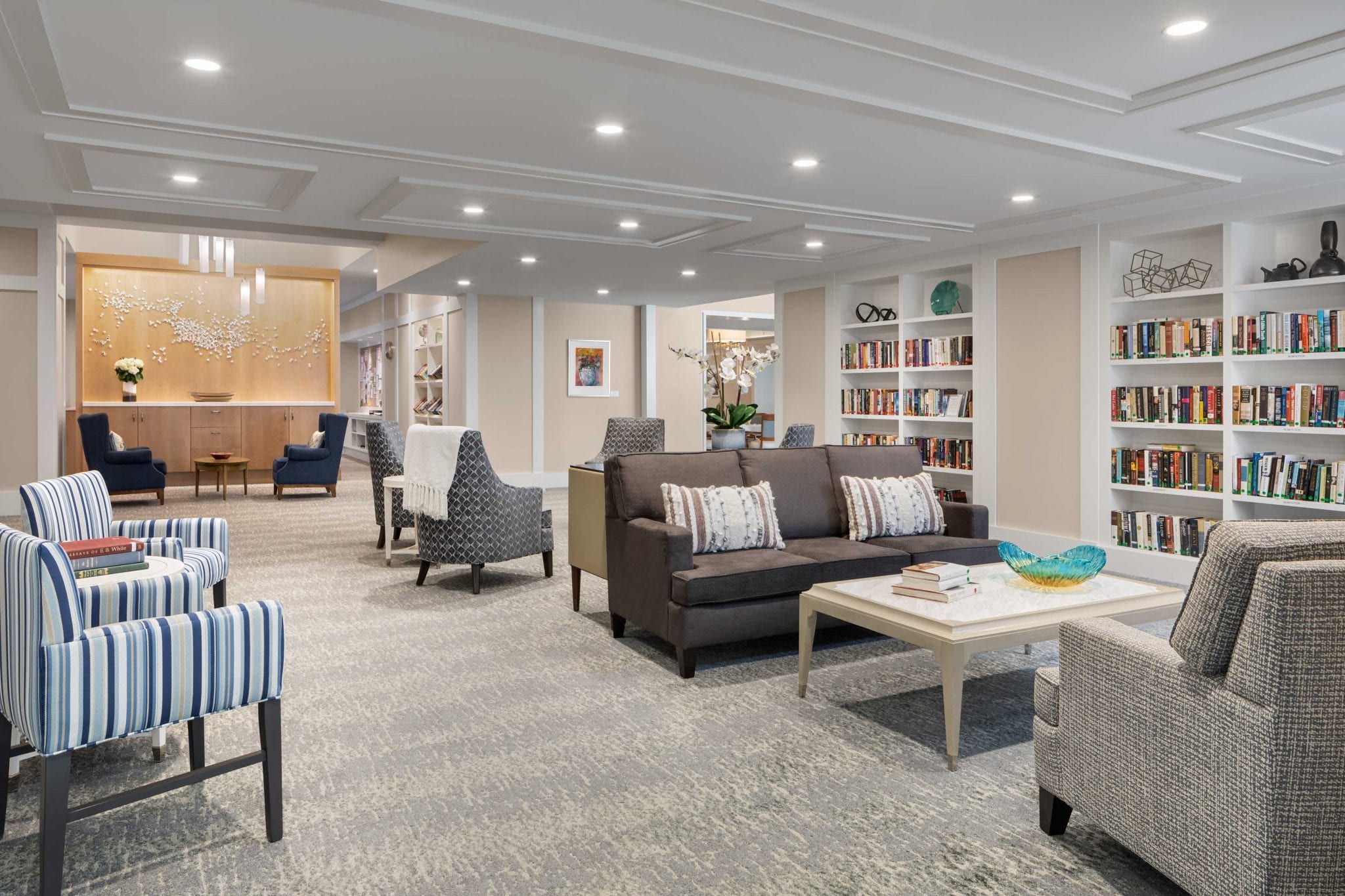 Interior view of a cozy common area with seating and bookshelves