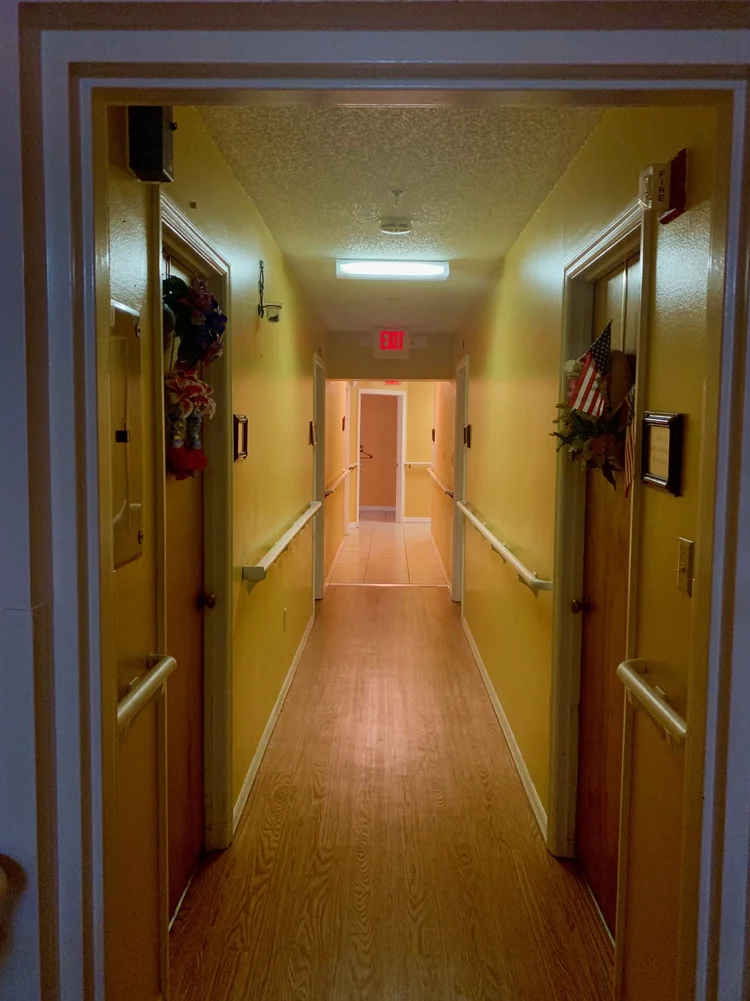 Bright hallway with yellow walls and decorated doors