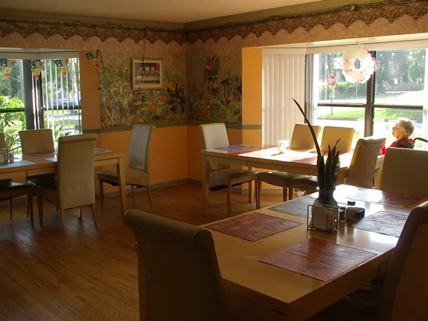 Interior dining area with tables and a resident