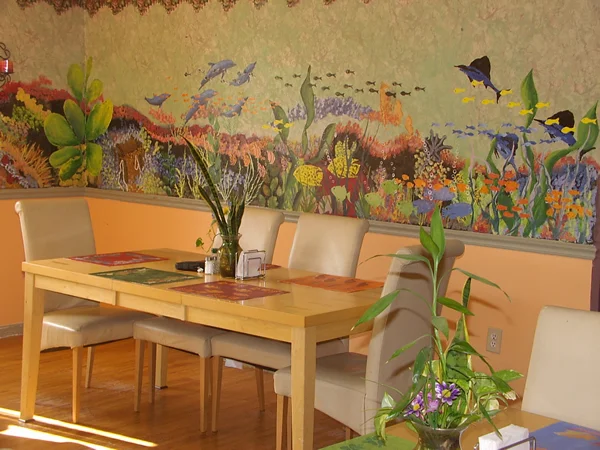 Brightly decorated common area with a dining table