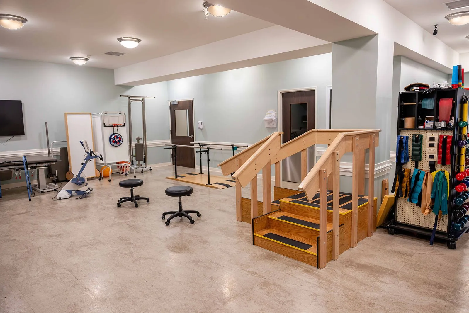 Interior activity space with therapy equipment and stairs