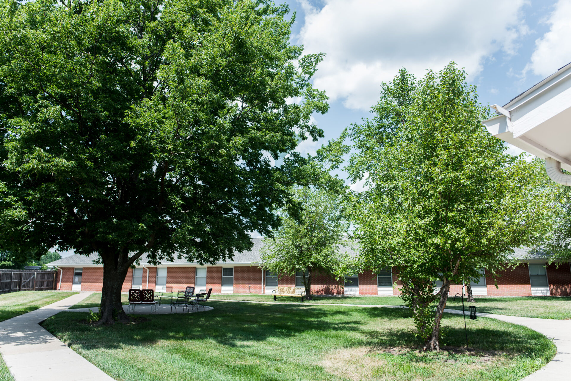 Outdoor space with trees and pathways in a senior living facility