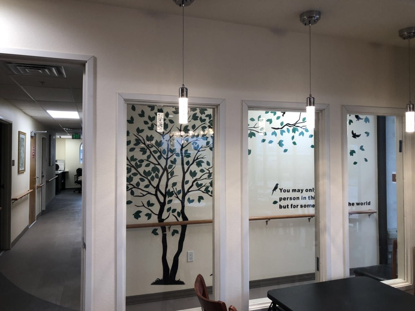 Interior view with tree mural and text on wall