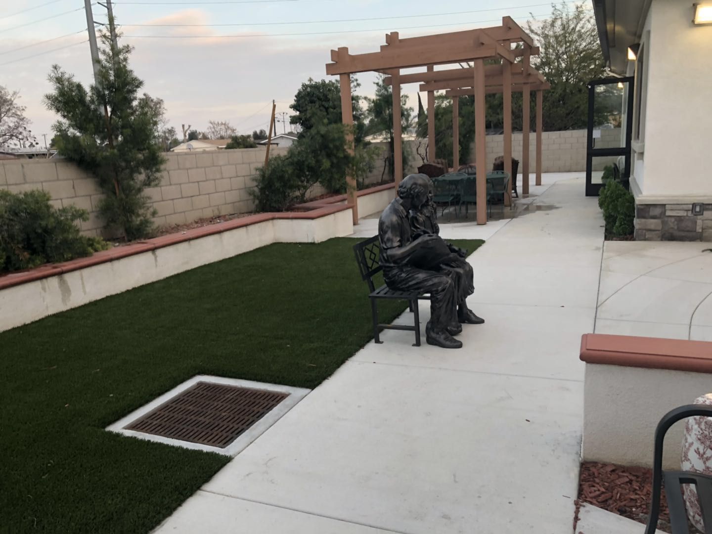 Outdoor seating area with a statue and landscaping