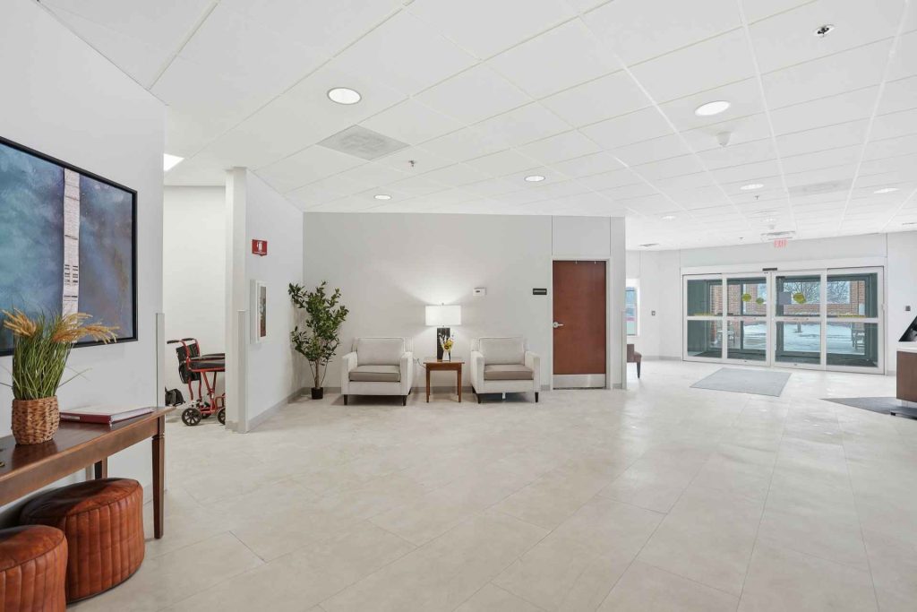 Bright lobby area with seating and entry doors