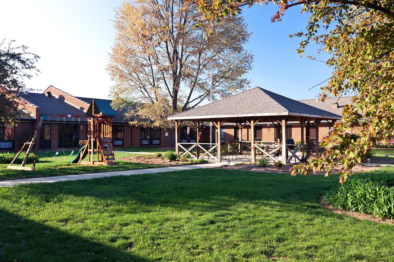 Outdoor play area with gazebo and playground
