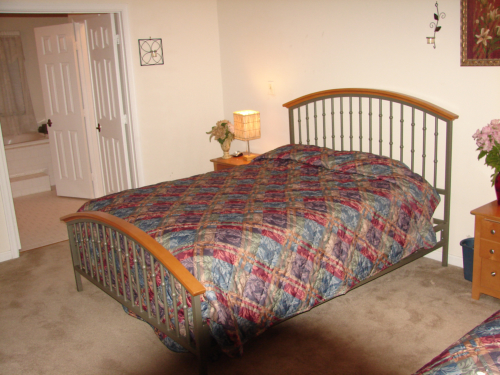 Well-furnished resident bedroom with decorative bedding