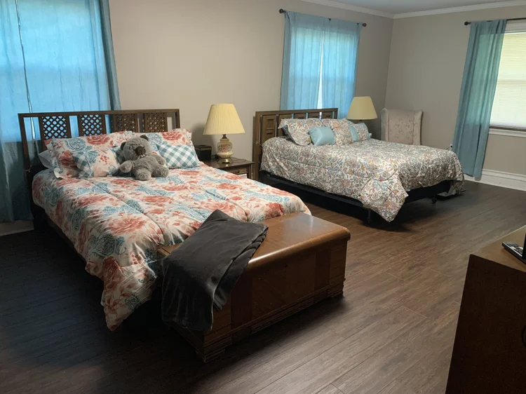 A cozy resident bedroom with two beds and decorative bedding