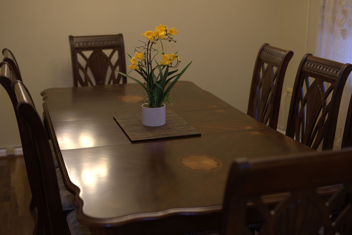 Well-furnished dining area with flowers on the table